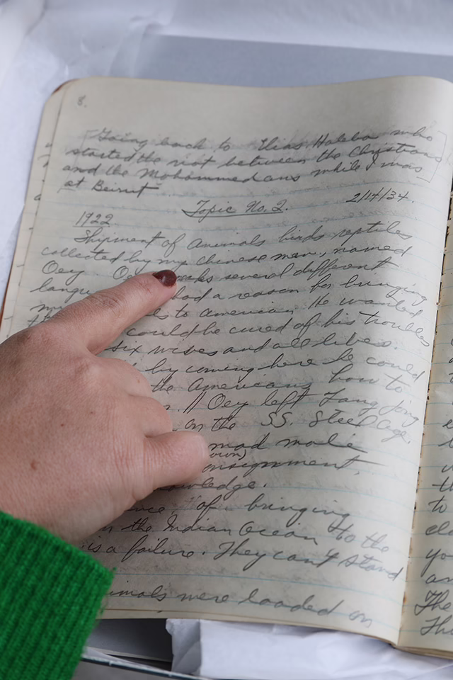 Photo of Sophie pointing at entry from 1922 in the Bistany journal