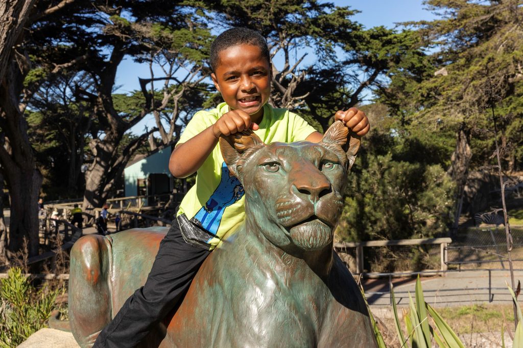 Child on statue smiling